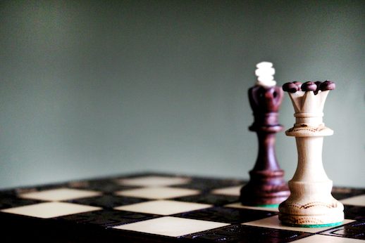 Wooden chess king and queen on a board